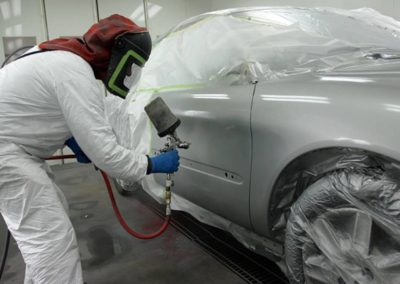 man spray painting the car