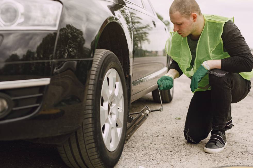 towing man preparing a car for towing